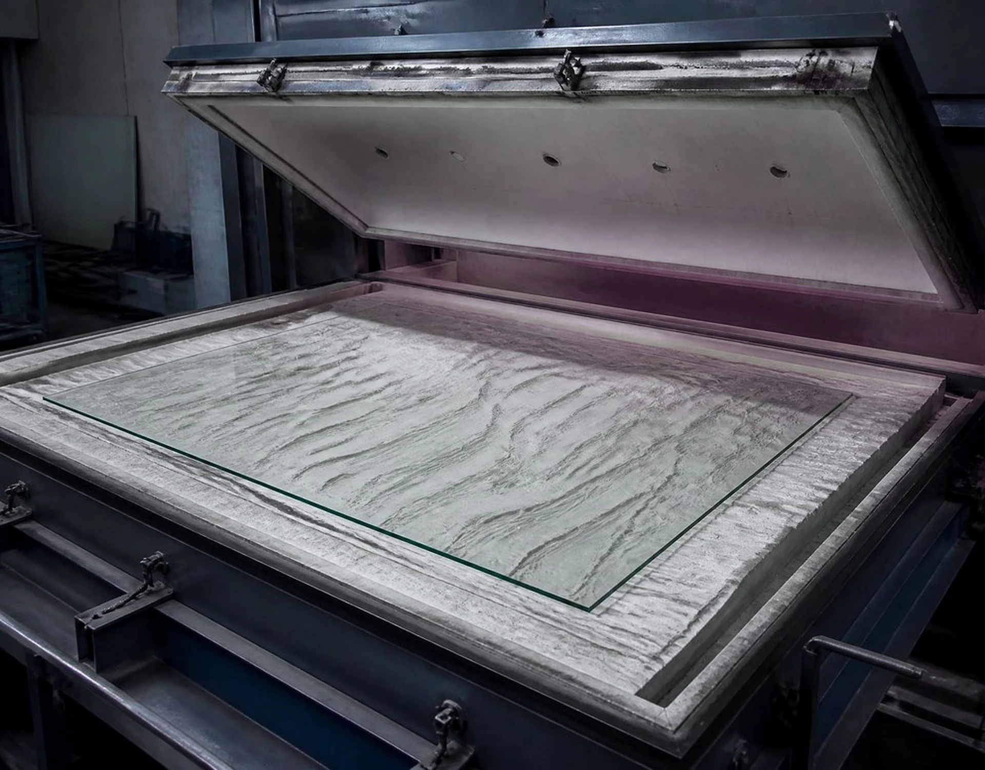 Molten glass poured into a refractory mould during kiln forming